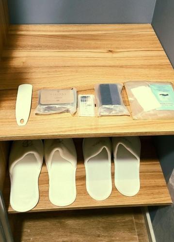 a shelf with white shoes and other items on it at Нові Ексклюзивні Апартаменти біля Софіївського Парку in Umanʼ