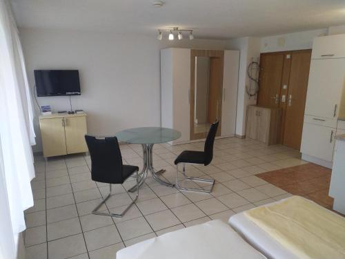 a living room with a table and two chairs at Hotel Victoria in Weil am Rhein