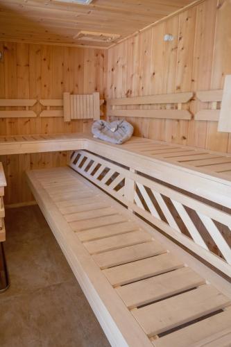 a sauna with wooden walls and wooden bunk beds at Zirbenchalet Grossglockner in Heiligenblut