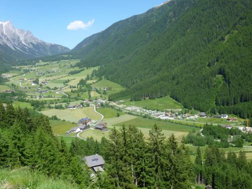 a village in a valley in the mountains at Hotel Gran Pre in San Vigilio Di Marebbe