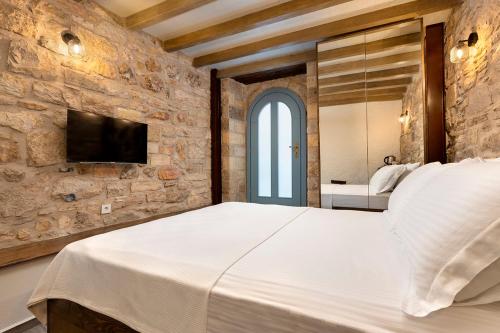 a bedroom with a large bed in a stone wall at EFLIN HAUS Historical Place & Monument in Cesme