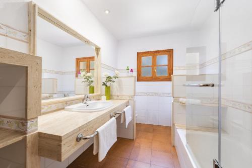 a bathroom with a sink and a shower at Villa Ramis by JS Villas in Cala de Sant Vicenc