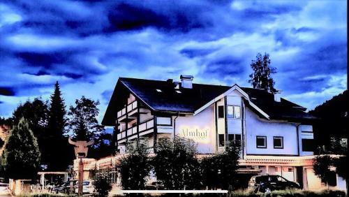 a house with a sign on the side of it at Almhof Kitzlodge - Alpine Lifestyle Hotel in Kirchberg in Tirol