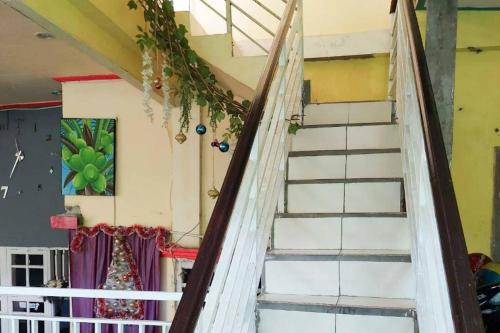 a staircase leading up to a room at Quattrick Dee Homestay Mitra RedDoorz in Manokwari