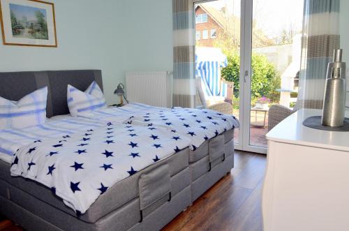a bedroom with a large bed with blue stars on it at Ferienhaus Felix in Heiligenhafen