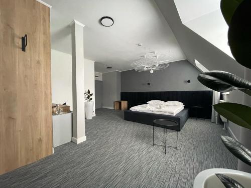 een slaapkamer met een bed en een kroonluchter bij Hotel Made in Napoli by Siervo Międzybórz in Neumittelwalde