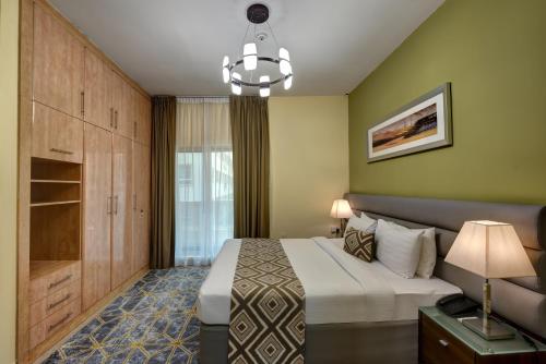 a bedroom with a large bed and a large window at Radiance Premium Suites in Dubai