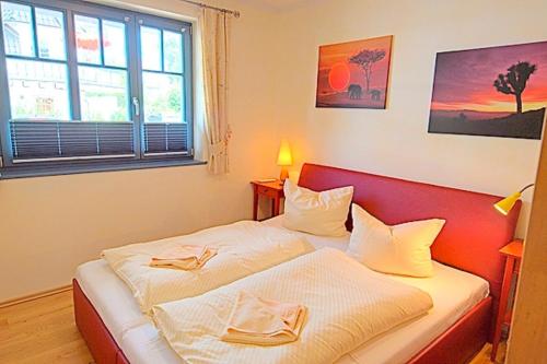 a bedroom with two beds with towels on them at Villa Birkenboom, FW 1 in Zingst