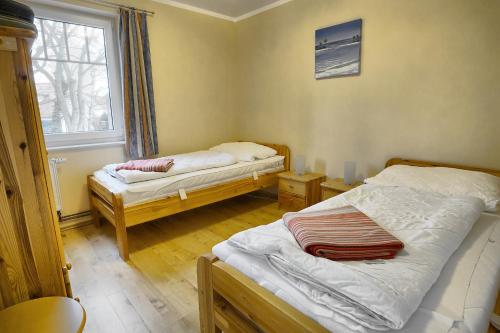 a room with two beds and a window at Robbe FW 4 in Zingst
