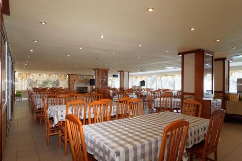 a dining room with a table and chairs and tables and chairsktop at Hotel Pliska All inclusive in Golden Sands