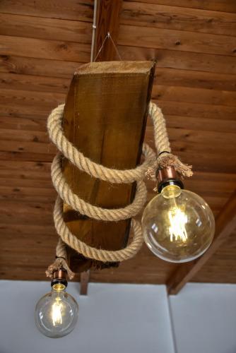 aendant light with a rope and lights on a ceiling at Iraklis Apartments in Stalida