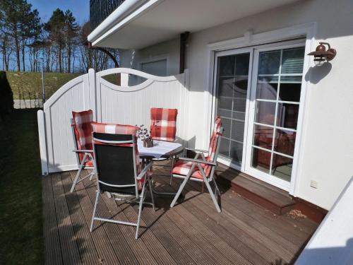 a patio with a table and chairs on a deck at Strandresidenz Deichgraf 2 Prerow in Zingst
