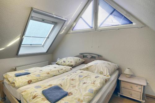 a bedroom with a bed and a window at Nele, Whg 3 in Zingst