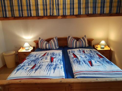 a bedroom with a bed with two pillows on it at Haus Weidenhof App 1 in Prerow