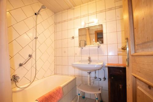 a bathroom with a sink and a toilet and a tub and a sink at Schoners Einfanghof WILD006 in Niederau