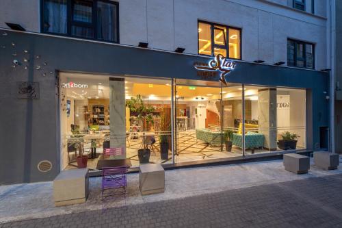 a store front with a purple table and chairs in it at Athens Starlight Hotel in Athens