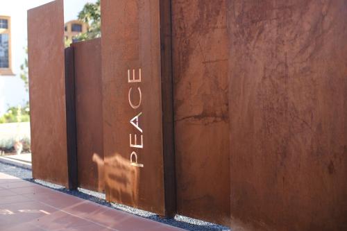 a sign on a wall with the wordulum on it at Sanctuary Mandela in Johannesburg