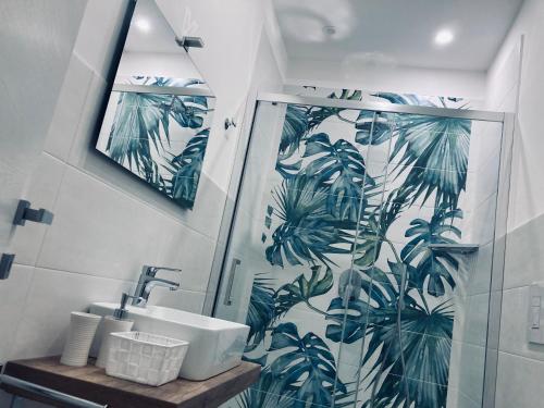 La salle de bains est pourvue d'une douche, d'un lavabo et d'un miroir. dans l'établissement B&B Miglio Sacro, à Naples