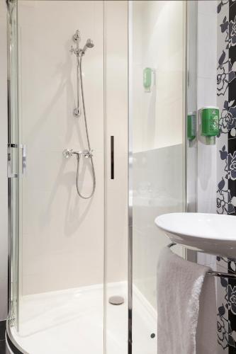 a bathroom with a shower and a sink at Hôtel Aurore Paris Gare de Lyon in Paris