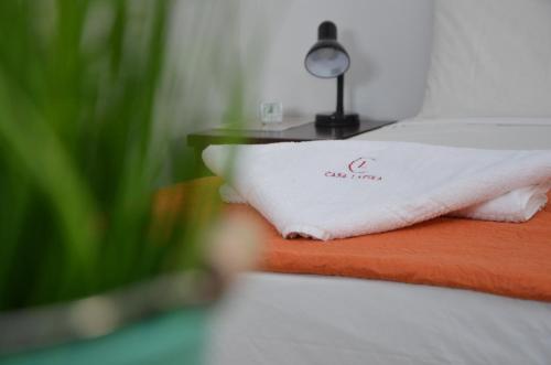 a bed with a white towel on a table at Casa Lapira in Valletta