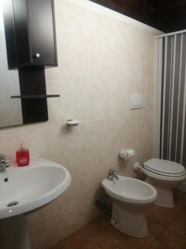 a bathroom with a white sink and a toilet at Holiday Residence in Casamassima