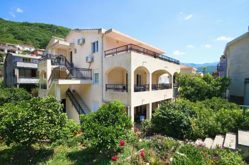 an apartment building with balconies and trees at Apartments Raičević in Budva