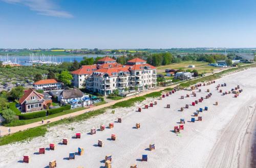 an aerial view of a beach with chairs and condos at Strandburg Aquamarin in Burgtiefe auf Fehmarn 