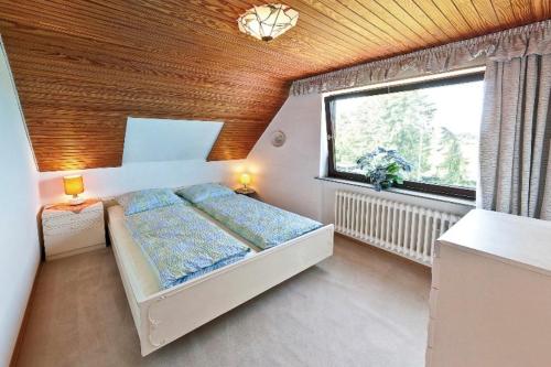 a small bedroom with a bed and a window at Gisela Werner in Groß Wittensee
