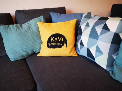 a couch with pillows and a kx supplements pillow at KaVi Apartments #3, TOP city view! in Plzeň