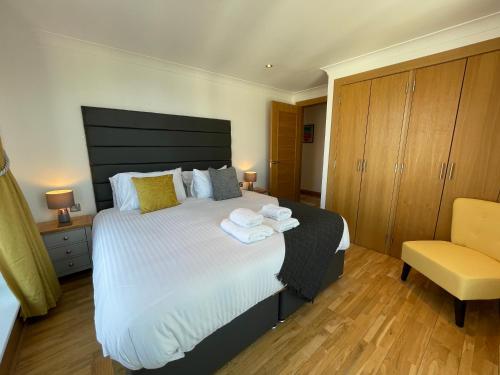 a bedroom with a large bed with towels on it at Principal Apartments - Merchant City in Glasgow