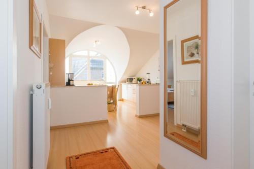a kitchen and a living room with an arched window at Likedeeler Weg 1 Whg 24 in Zingst