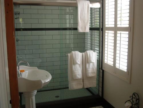 a bathroom with a sink and a shower with towels at Jamestown Hotel in Jamestown