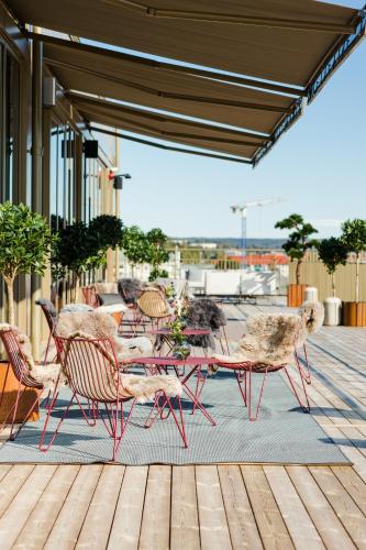 a group of chairs and tables on a patio at Clarion Hotel Sundsvall in Sundsvall