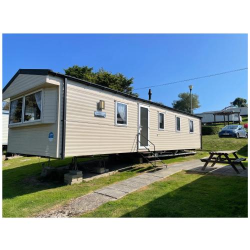 a tiny house is parked in a park at Cosy 3-Bed Caravan combe haven st Leonards on sea in Hollington