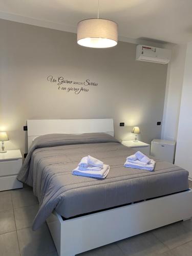 a bedroom with a bed with two towels on it at BELLA ASSISI B & B in Assisi