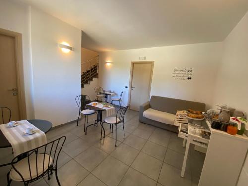 a living room with a couch and a table and chairs at BELLA ASSISI B & B in Assisi