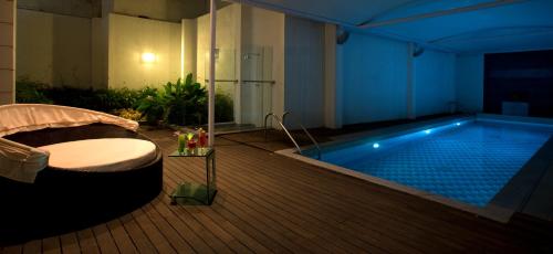 a large swimming pool with a tub in a room at Springs Hotels and Spa in Bengaluru