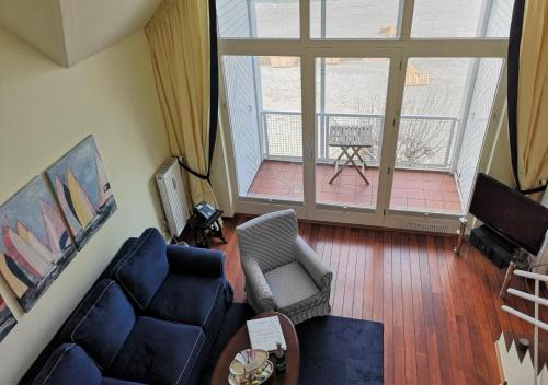 uma sala de estar com um sofá e uma varanda em Soling em Laboe