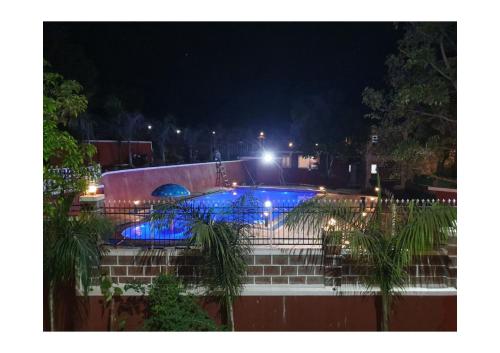 - une piscine avec des lumières bleues la nuit dans l'établissement 3BHK ALLADIN VILLA (COMMON POOL), à Mahabaleshwar
