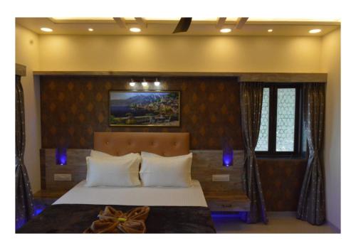 a bedroom with a large bed with blue lights at 3BHK ALLADIN VILLA (COMMON POOL) in Mahabaleshwar