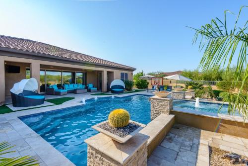 a backyard with a swimming pool and a house at Casa Cielo home in Scottsdale