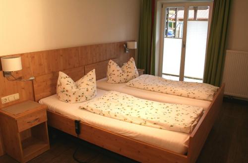 a bedroom with two twin beds with pillows at Setzberg in Bad Wiessee