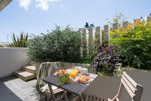 a table with a plate of food on a patio at I Loft Santiago by Upper Luxury Housing in Santiago de Compostela