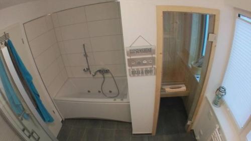 a bathroom with a shower and a bath tub at Marina Villa in Kappeln
