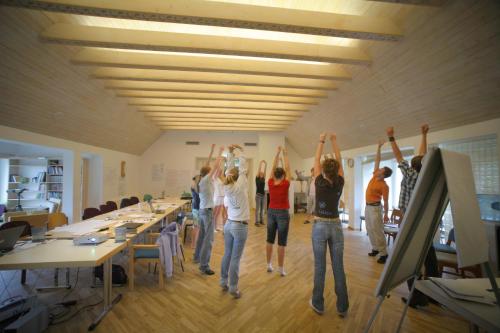a group of people standing in an office with their arms in the air at Altmõisa Guesthouse in Tuuru