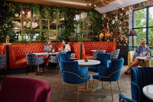 people sitting at tables in a restaurant with plants on the wall at The Montenotte Hotel in Cork