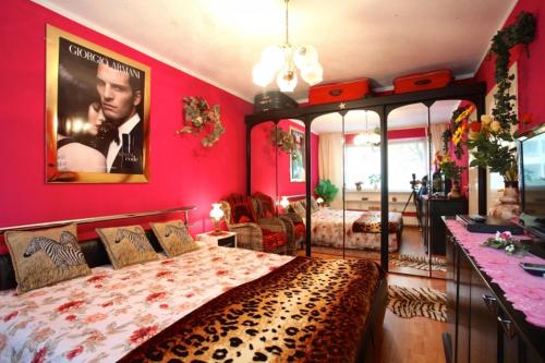 a bedroom with a large bed with a poster on the wall at Private Rooms in Hannover