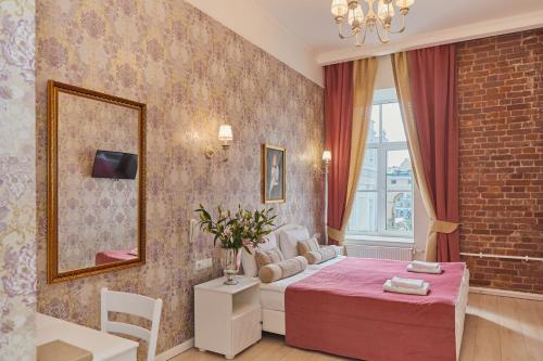 a hotel room with a bed and a couch at Grand Catherine Palace Hotel in Saint Petersburg