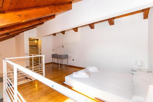a room with a white bed and a table at Central&Lovely Savoia Loft in Turin