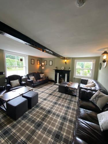 a large living room with couches and a fireplace at The Bickerton Poacher in Higher Burwardsley